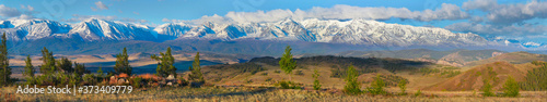 Large panorama, view of the snow-covered mountain range. Traveling in the mountains, hiking.