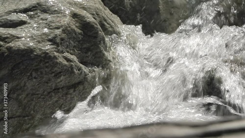 Detail shot in slowmotion of how the water falls between rocks in the Venosc river, French Alps. Pro Res photo