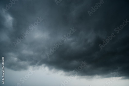 dark storm clouds with background,Dark clouds before a thunder-storm. © pinglabel