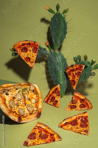 Creative layout of hot delicious pizzas with cactus on mustard  background. Pizza pepperoni and vegetable pizza design or poster for promotions and discounts with copy space. Fast Food concept photo