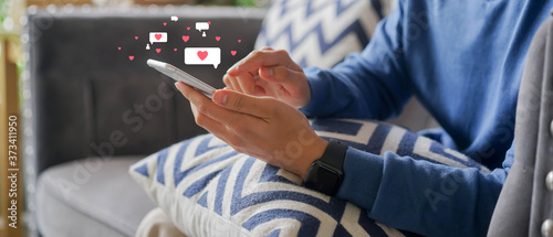 close up young man holding smartphone while using online dating application to greeting and talking with other for appointments to flirting for lifestyle people concept