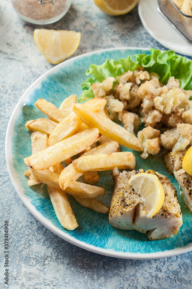 Steamed cod fish with french fries and boiled cauliflower