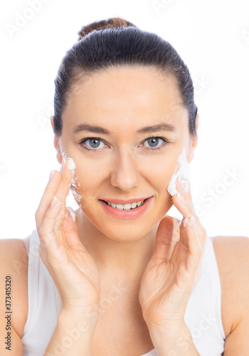 Beautiful young woman using foaming cleanser. Face washing concept isolated on white background