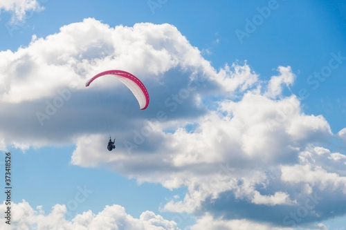 Paragliding in the sky on a sunny day.