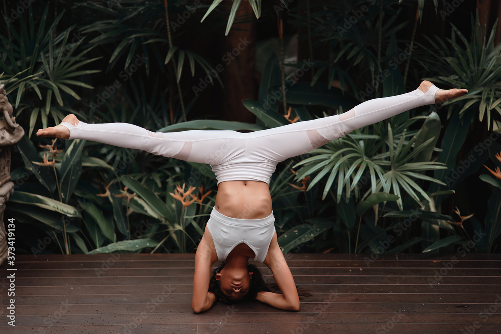 Asia Yoga instructor, in outdoor exercise. Portrait of gorgeous asian young woman practicing yoga outdoor