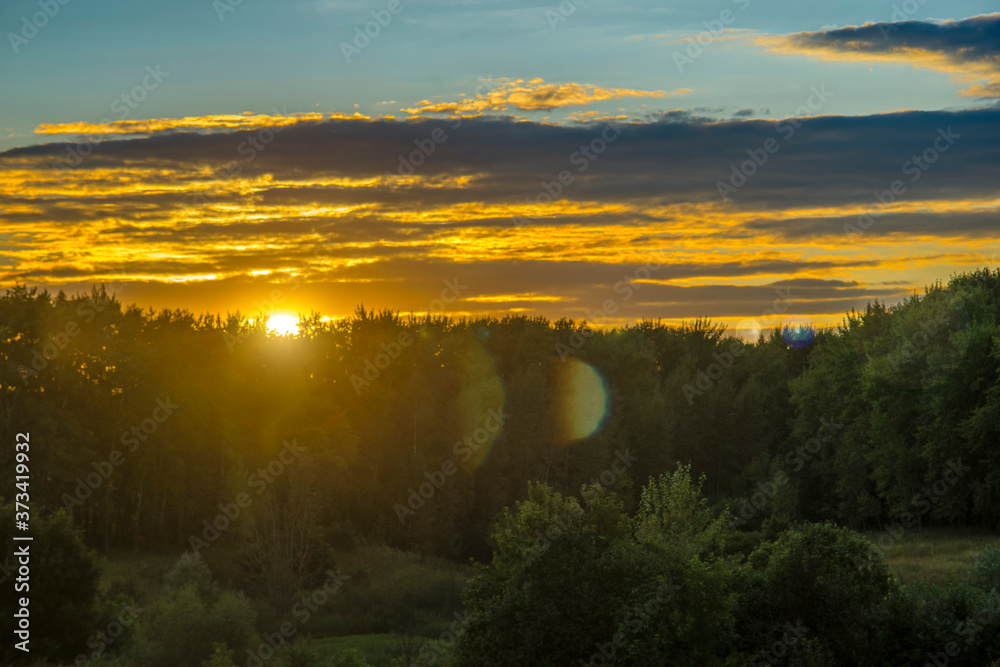 Obraz premium Sunset rural farm meadow horizon view. Cloudy sky.