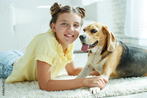 Wallpaper Mural Child with a dog. Teenage girl with a beagle dog at home. High quality photo. Torontodigital.ca