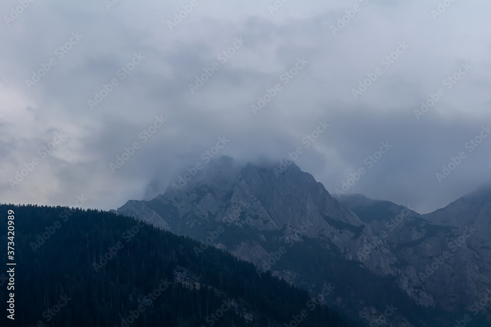 Misty fog after rain on Austia Alps mountain with sky