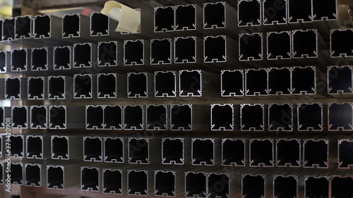 Industry business production and heavy metallurgical industrial products, many shiny aluminium profiles, industrial background, manufacturing business production concept