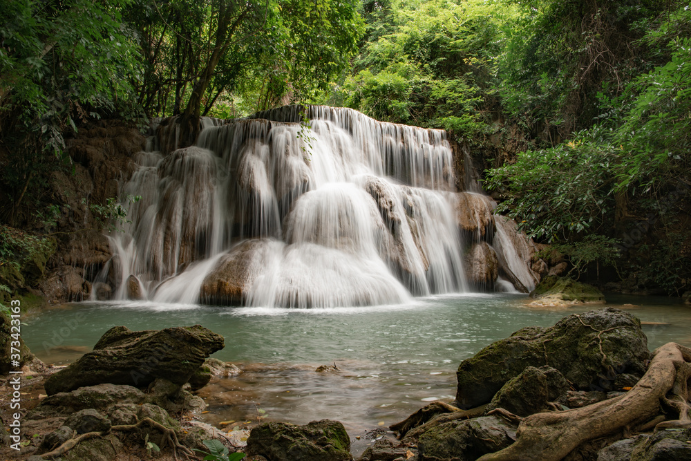 Fototapeta premium Huay Khamin waterfall with 7 levels located in Kanchanaburi in the midst of nature with green trees. Cold flowing water