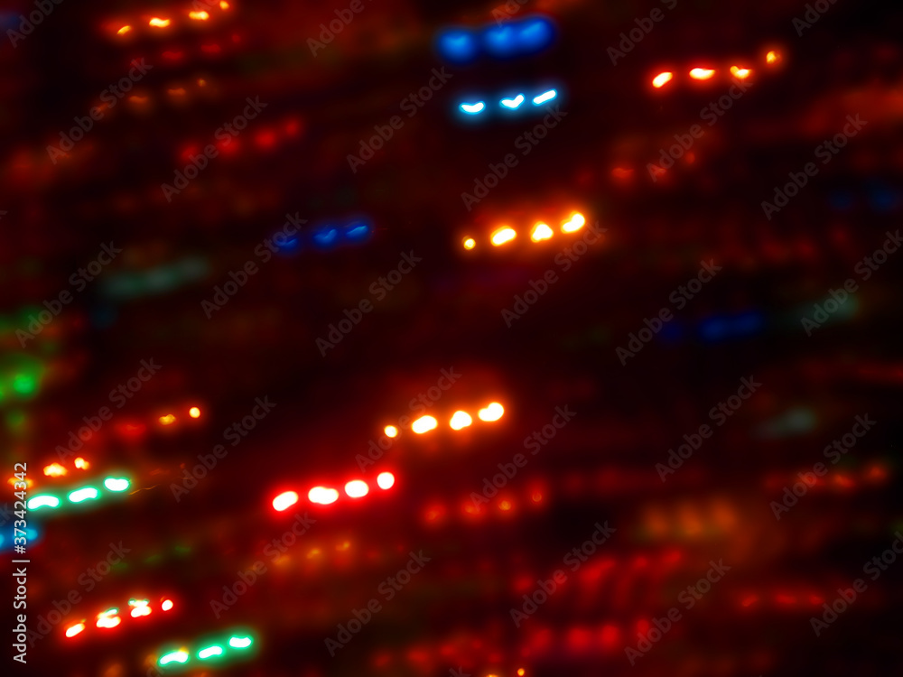 Obraz premium Blurred colored holiday lights as background.