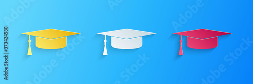 Paper cut Graduation cap icon isolated on blue background. Graduation hat with tassel icon. Paper art style. Vector.
