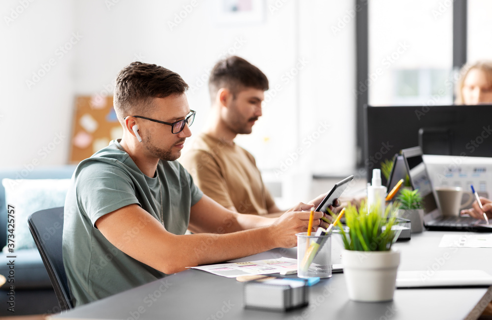 business, people and corporate concept - team of startuppers or ui designers working at office business, people and corporate concept - team of startuppers or ui designers working at office