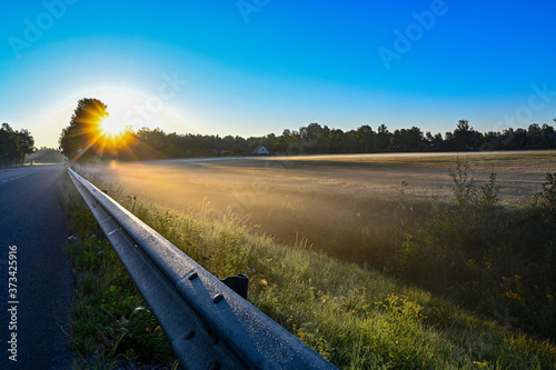 early sunrise over straight road with deminishing perspctive photo