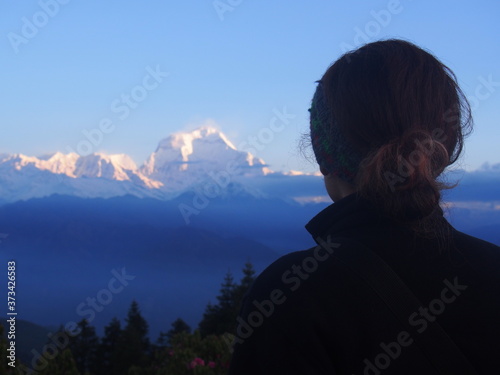 A woman looking great nature, A hill station "Poon Hill" overlooking the Annapurna Massif range and Dhaulagiri mountain range, ABC (Annapurna Base Camp) Trek, Annapurna, Nepal