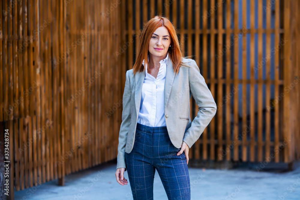 Confident business expert. Happy successful professional posing near office building. European girl. Russian business lady. Female business leader concept. Portrait Of Successful Business Woman Confident business expert. Happy successful professional posing near office building. European girl. Russian business lady. Female business leader concept. Portrait Of Successful Business Woman
