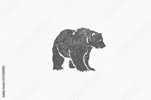 Black silhouette of bear as symbol of wild fauna in nature hand drawn stamp effect vector illustration.