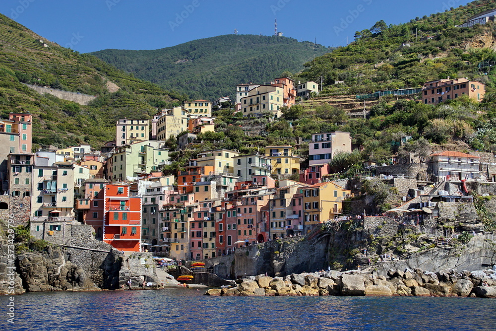 Riomaggiore is an ancient village with colorful houses and a small port, one of the Cique Terre sequence of hill cities on the Mediterranean sea coast in Liguria, Italy