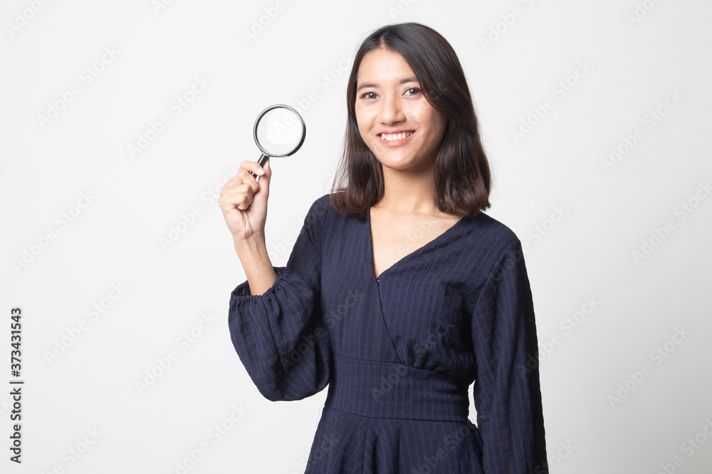 Young Asian woman with a magnifying glass. Young Asian woman with a magnifying glass.