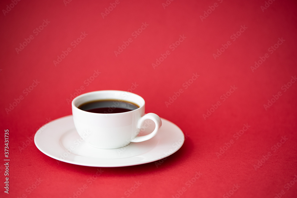 black coffee in a small coffee cup on a red background black coffee in a small coffee cup on a red background