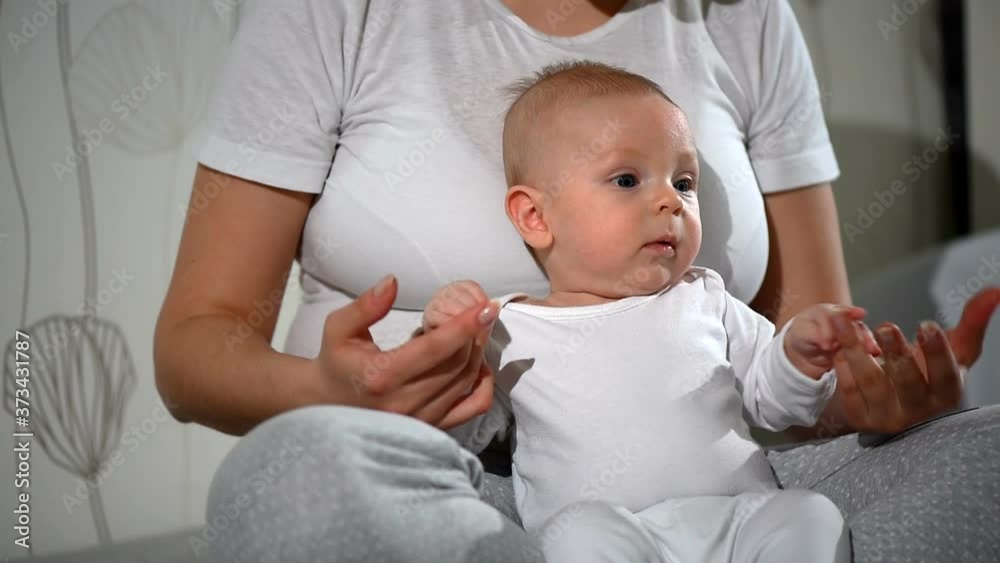 Beautiful young mother girl playing with her newborn baby Beautiful young mother girl playing with her newborn baby