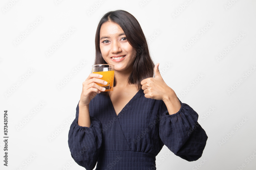 Young Asian woman thumbs up drink orange juice. Young Asian woman thumbs up drink orange juice.