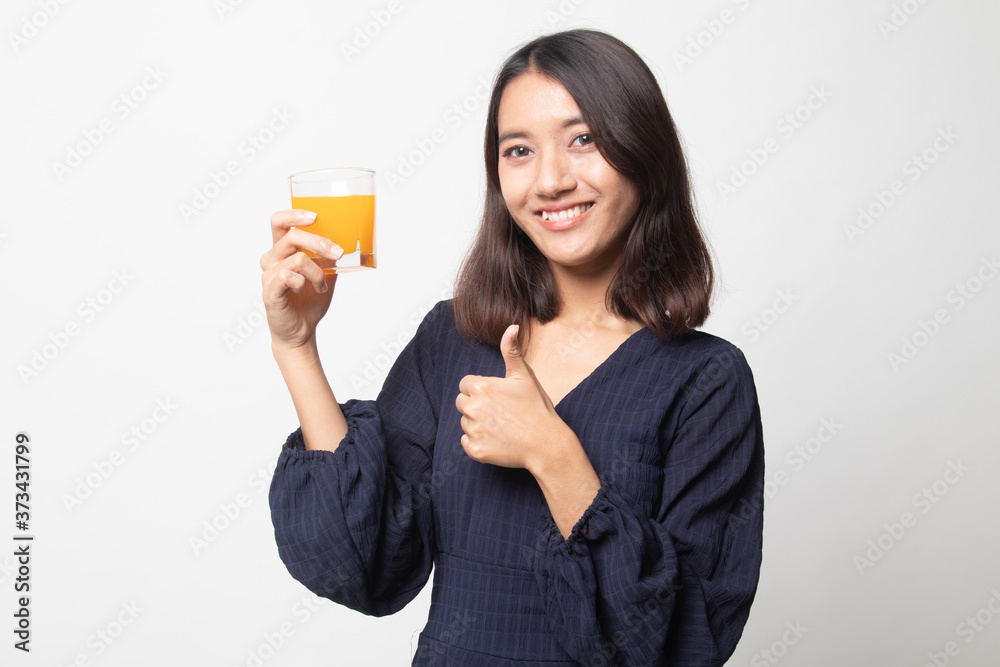Young Asian woman thumbs up drink orange juice. Young Asian woman thumbs up drink orange juice.