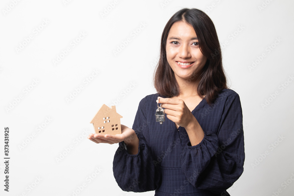 Happy young asian woman with house model and key. Happy young asian woman with house model and key.