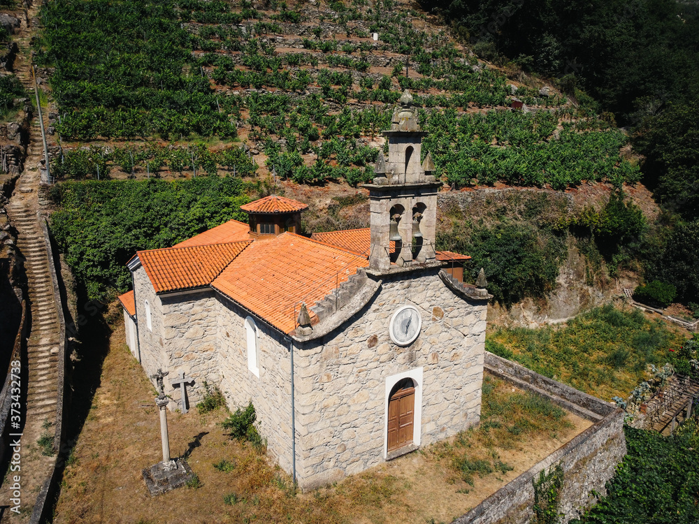Aerial view of church in vineyard on a hill. Belesar in Ribeira Sacra, Ourense, Spain