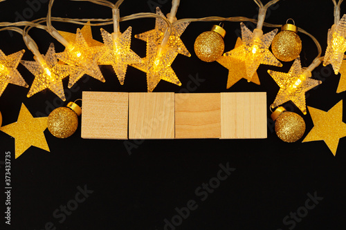 Four wooden blocks with deocrative stars. New Year concept photo