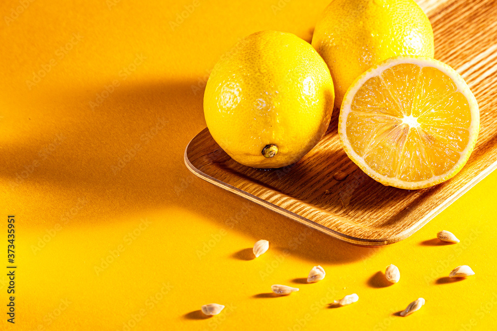  lemon and lemons on the wood at orange background