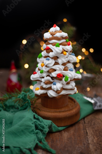 Baked gingerbread christmas tree on wooden background. Close-up