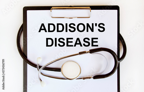 The inscription on the paper tablet is ADDISON'S DISEASE. Around the tablet stethoscope. photo