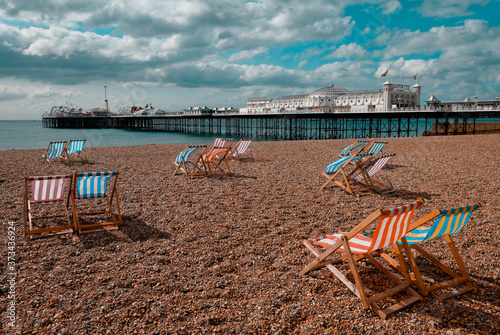 Brighton, England - September 11, 2009: Empty Deckchairs on Beach next to Brighton Pier, First opened in 1899 © lenscap50