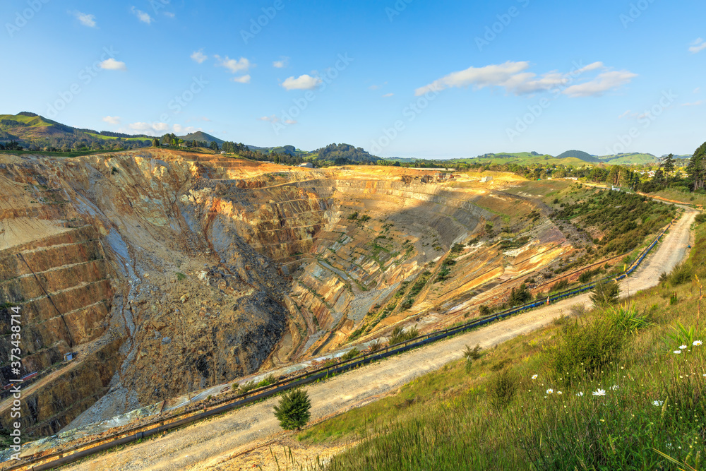 A large open-cast gold mine at Waihi, New Zealand. A slip has cascaded down the terraced side of the pit