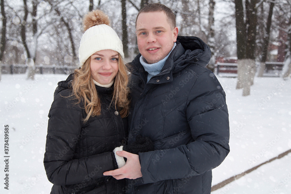 Young couple hugging in winter park Young couple hugging in winter park