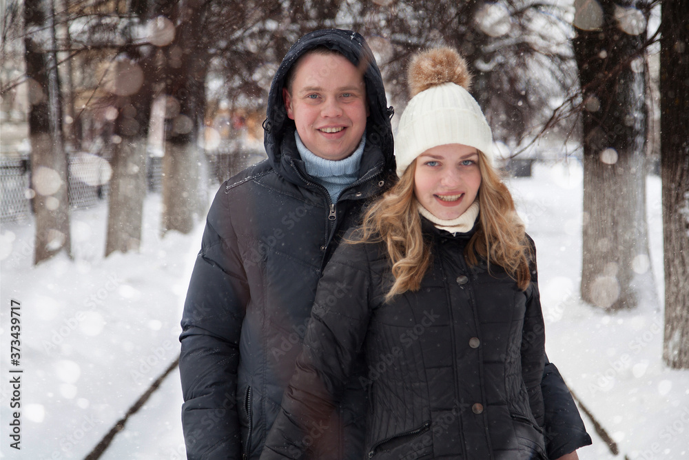 Young couple hugging in winter park Young couple hugging in winter park