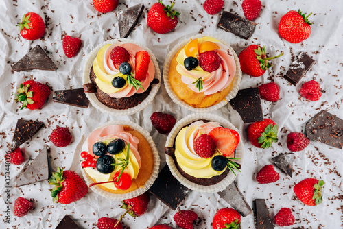 chocolate cupcakes with cream and fresh berries