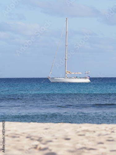 Beach and yacht on Atlantic Ocean at Sal island, Cape Verde - vertical