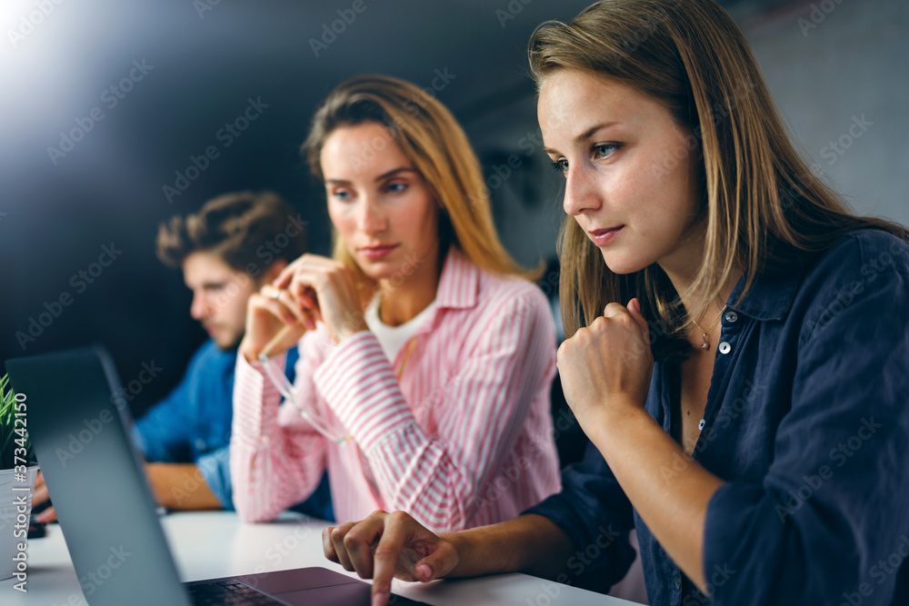 Group of young people working together. Creative business people in modern office. Startup concept Group of young people working together. Creative business people in modern office. Startup concept