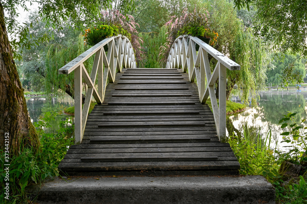 wooden bridge over water in beautiful park wooden bridge over water in beautiful park