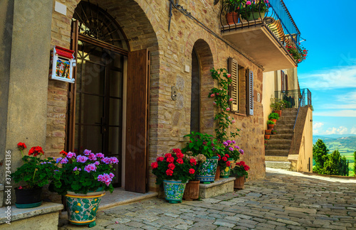 Flowery entrance and street view in Tuscany, Pienza, Italy