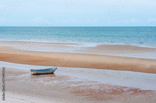 фотографія Vintage floating boat sea on beach with anchor, sea light in morning