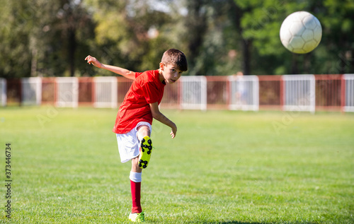 Young boy shooting soccer ball