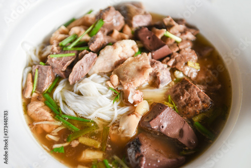 Delicious noodles bowl vermicelli noodles soup  with pork stew vegetable in bowl traditional thai and chinese style food of asia , Pork offal , Liver pork intestines