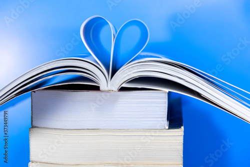 Stack of paper books on blue background