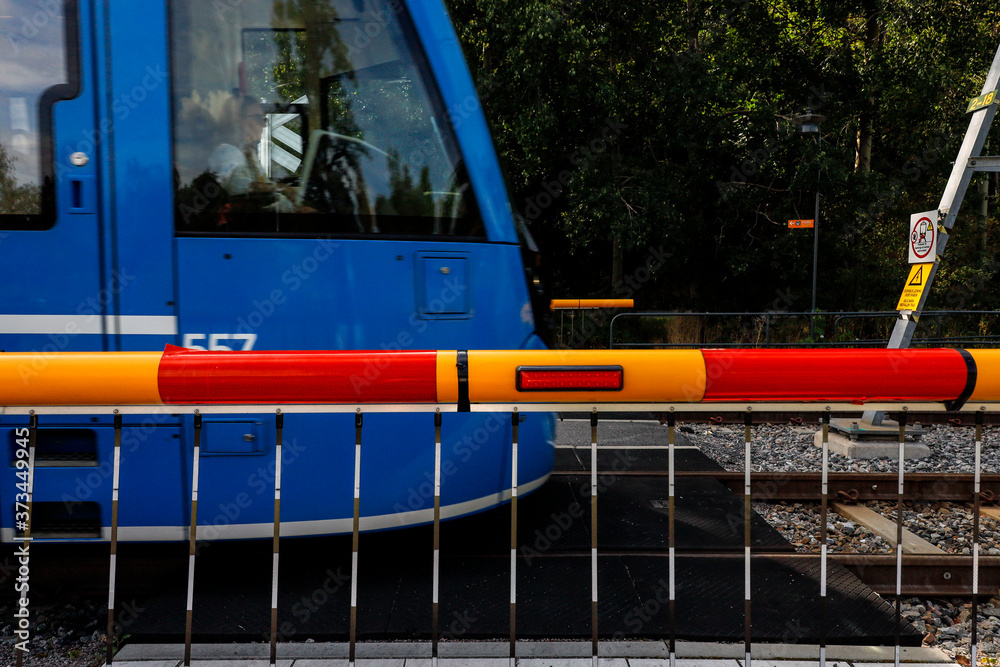 Stockholm, Sweden A tram on the Lidingo banan passes a closed safety gate. Stockholm, Sweden A tram on the Lidingo banan passes a closed safety gate.