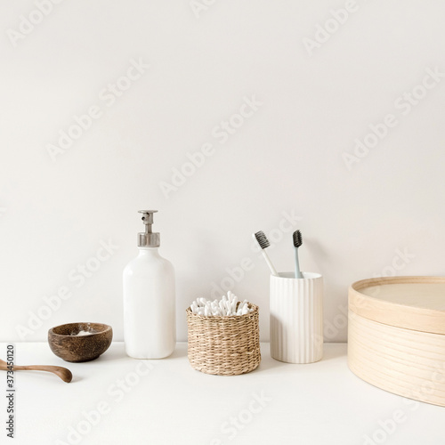 Beauty, health care morning routine products. Spa, wellness, treatment essentials. Toothbrushes, ear sticks, liquid soap cream on white table