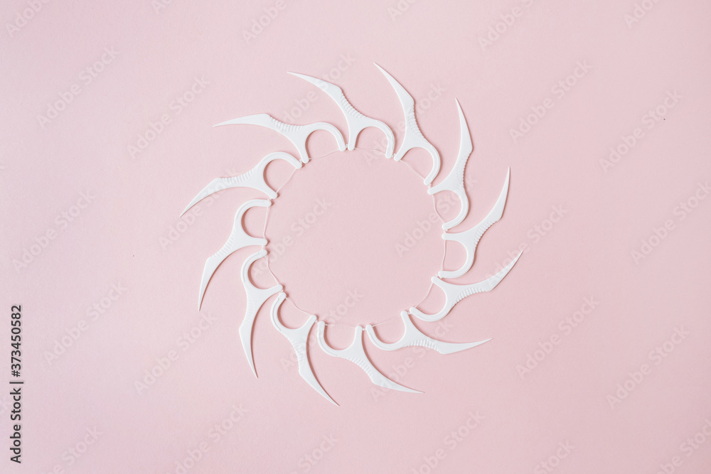 Round frame made of tooth flossers on pink background. Flat lay, top view minimal oral care, dental hygiene concept Round frame made of tooth flossers on pink background. Flat lay, top view minimal oral care, dental hygiene concept
