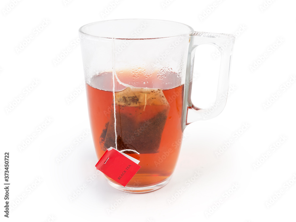 Freshly brewed black tea in glass cup with tea bag Freshly brewed black tea in glass cup with tea bag